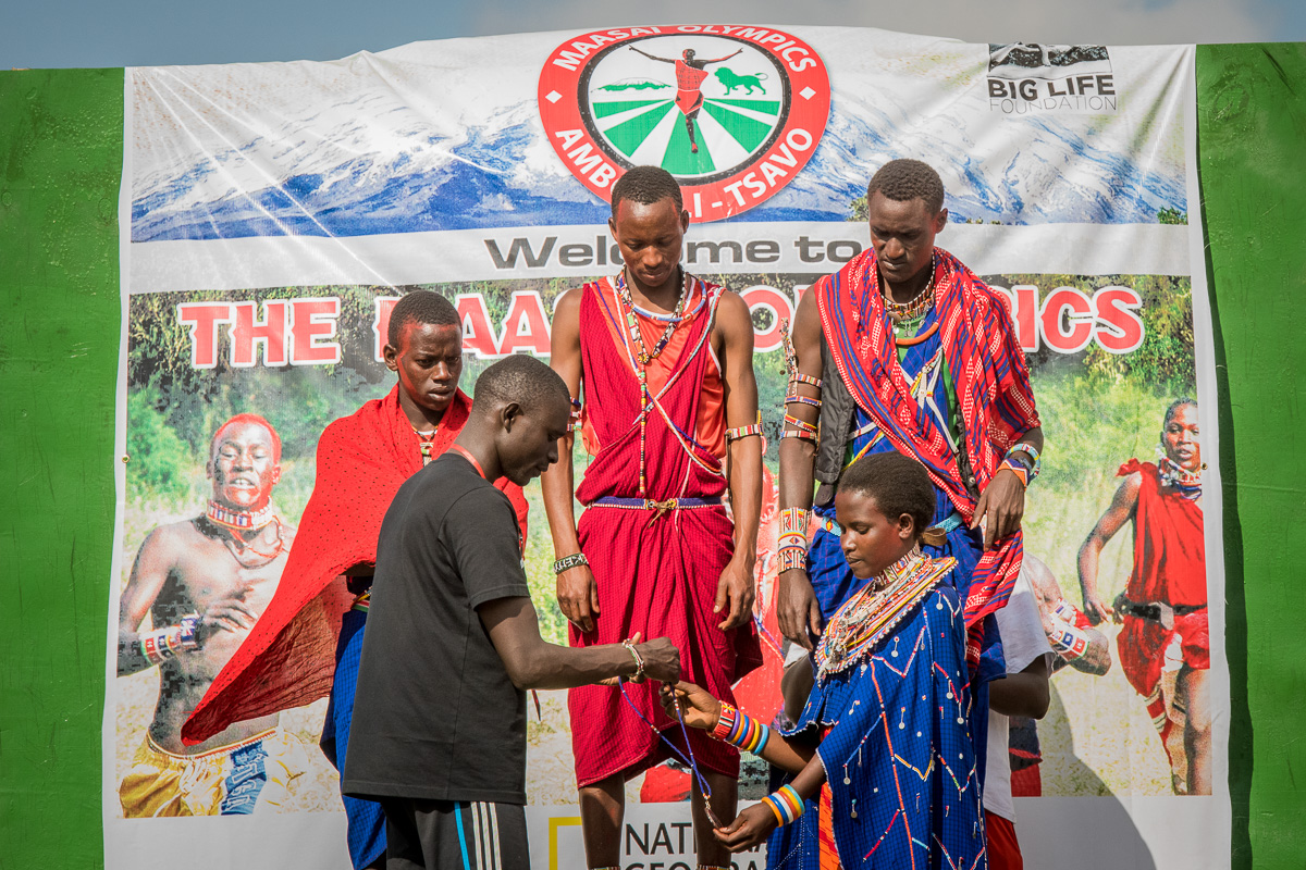 David Rudisha, Patron of the Maasai Olympics and himself a Maasai warrior, presents medals to 3 top winners.